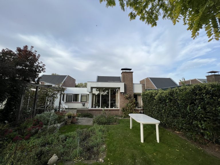 Dakrand en boeidelen met nieuwe witte beplating op woning met plat dak in Apeldoorn