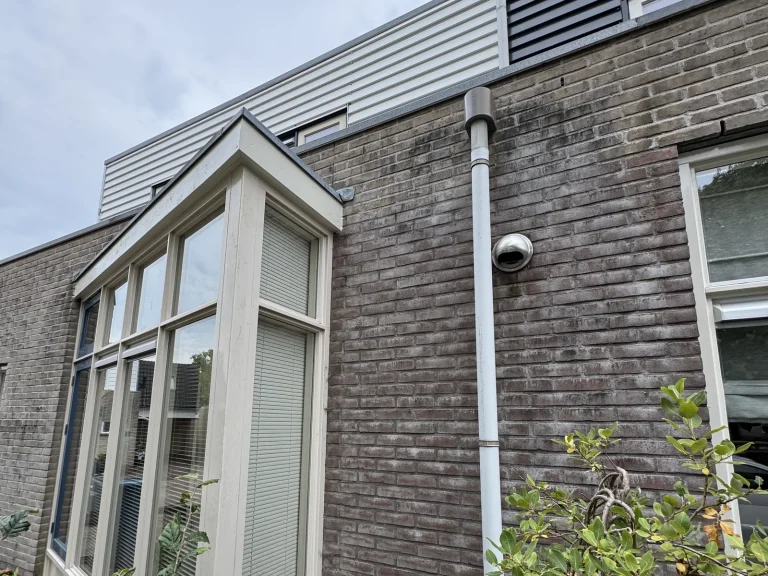 Zijgevel van de woning in Beekbergen met afgewerkte dakrand boven de raampartij